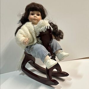 Porcelain Doll with Cream Sweater and White Shoes on Brown Rocking Horse